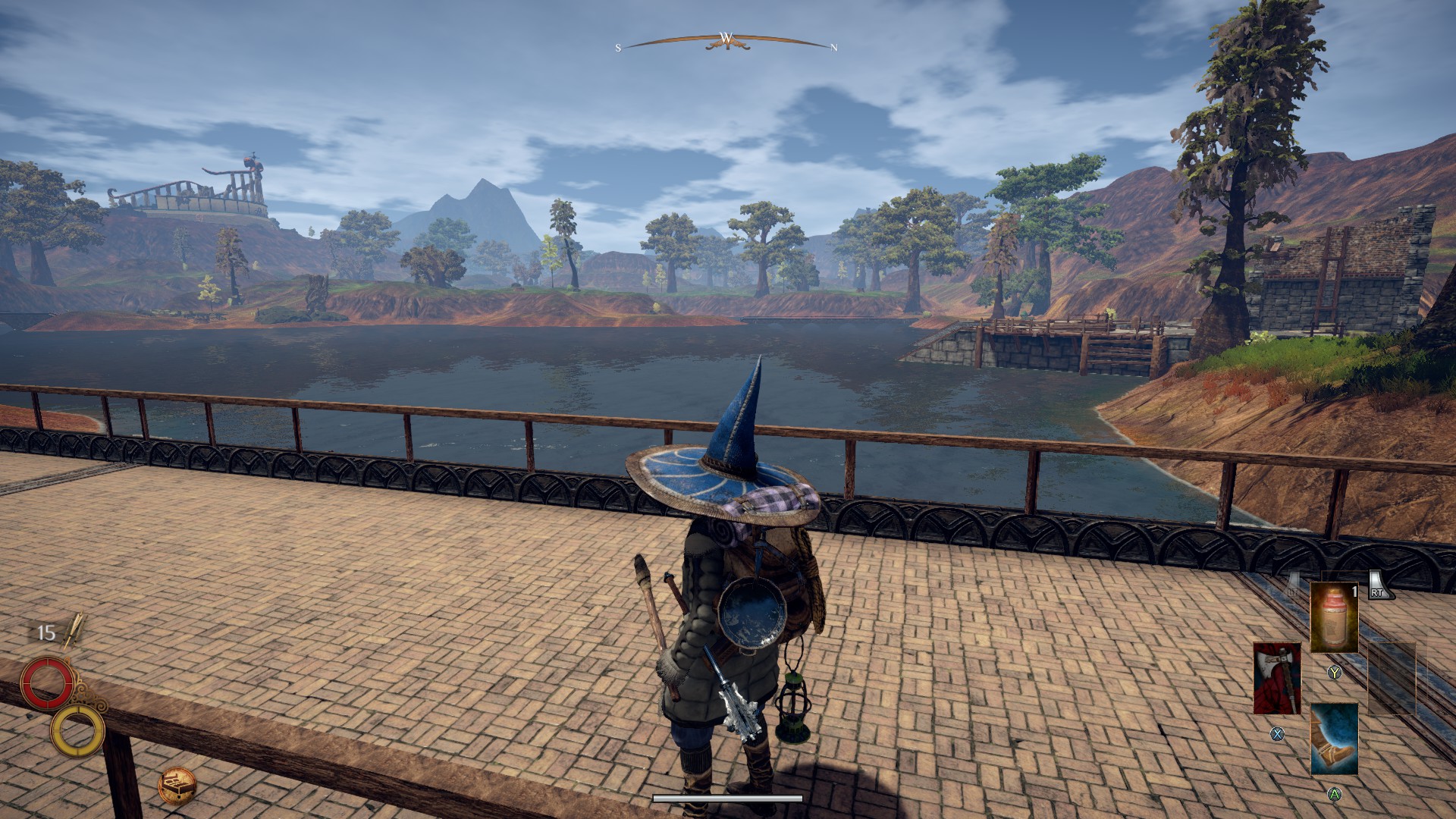 Outward screenshot; a heavily-laden witch crosses a wide bridge. At the edges of the lake are a small outpost and further away is a large ruin.