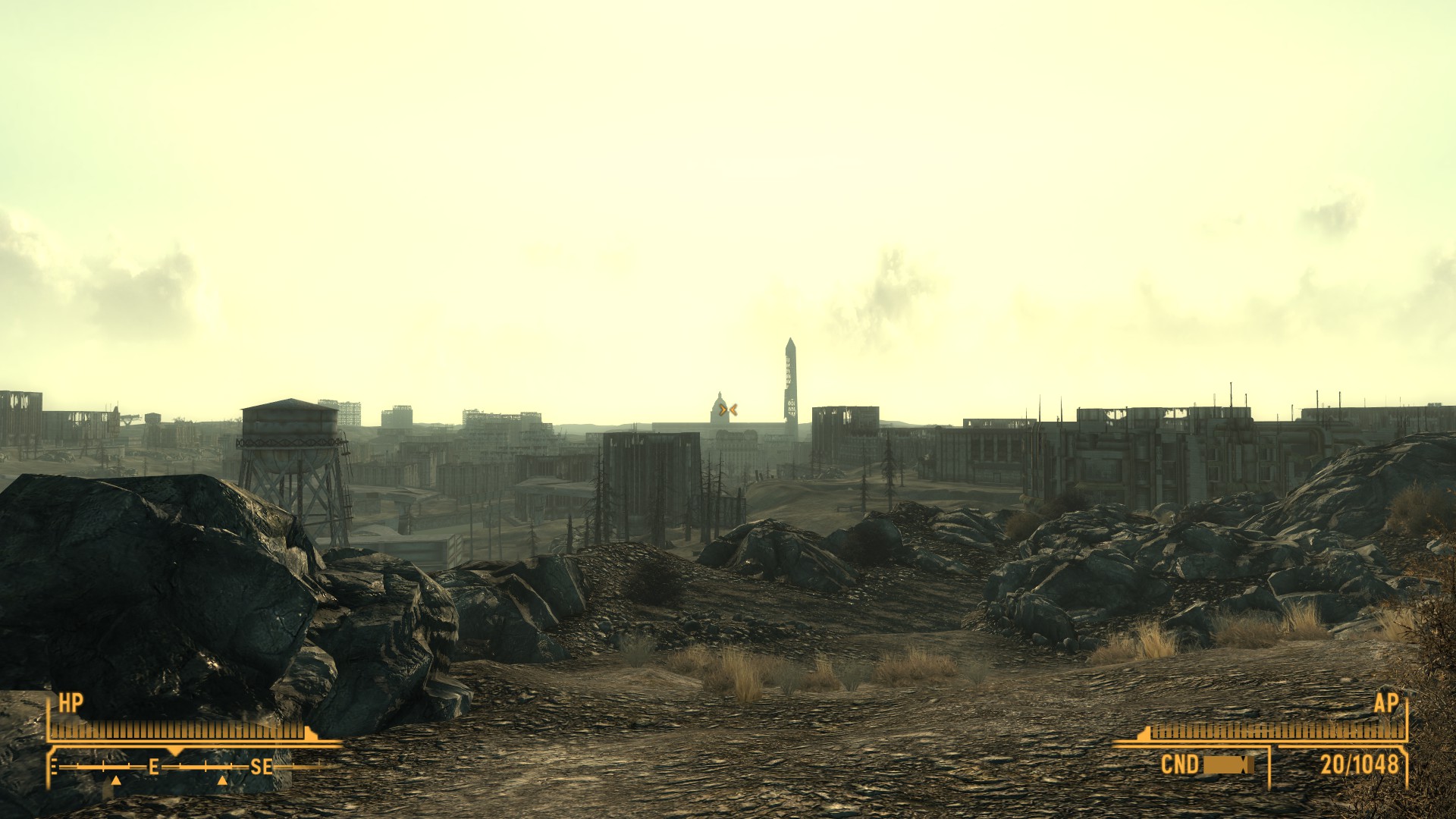 The distant, skeletal outlines of the US Capitol Building and Washington Monument are visible among other buildings across a rocky wasteland.